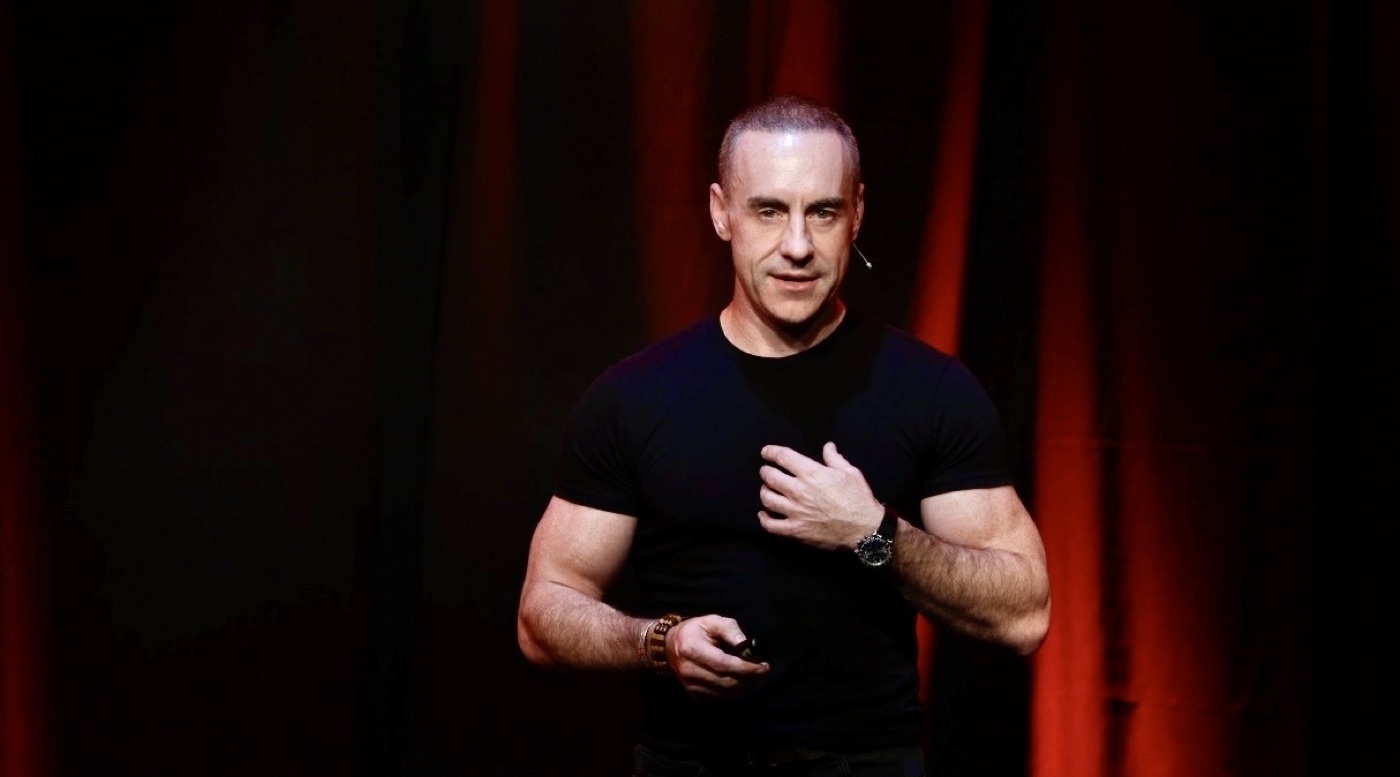 Bryan Adams delivering a keynote on the TEDx stage